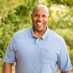 Smiling minister with trees in background