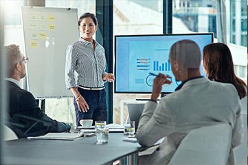 Woman presenting a recorded screen sharing presentation in a modern boardroom