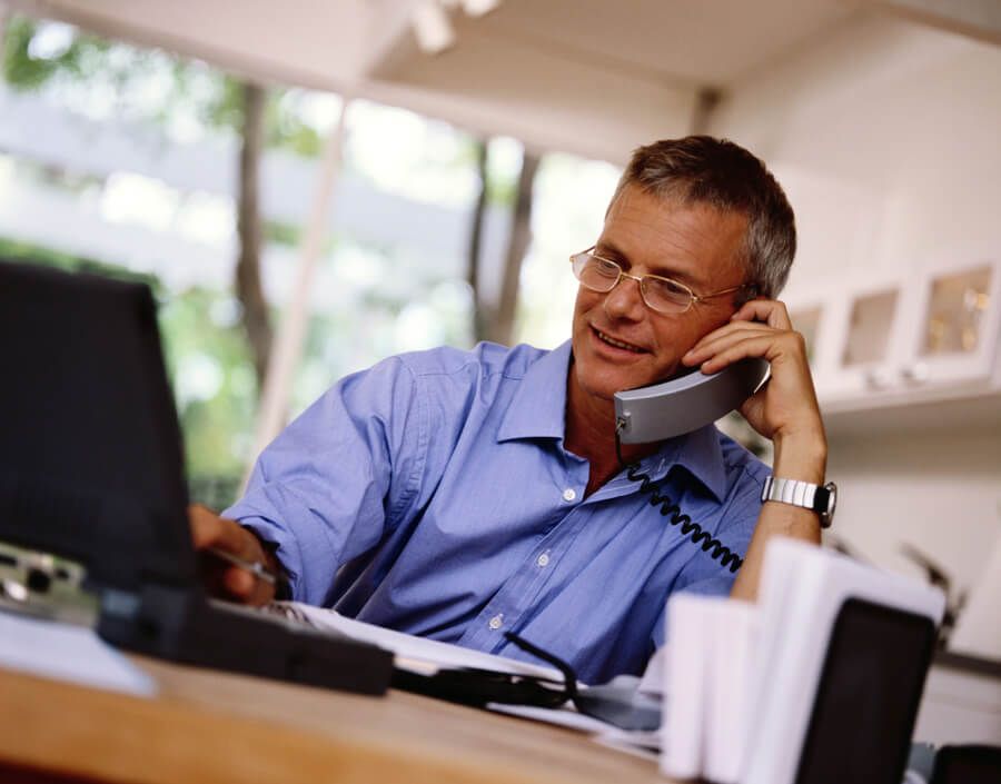 A man on his phone and laptop